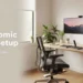A perfectly arranged ergonomic home office desk setup in 2026 showing correct monitor height, chair posture, keyboard position, and neutral sitting posture for productivity and pain prevention