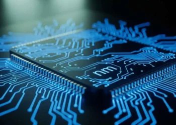 A photorealistic macro visualization of nanometre-scale transistors on a silicon chip glowing blue, representing the difference between nanometre and the fake term nometre