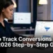 A digital marketer tracking conversions in Google Analytics 4 on a laptop showing key events dashboard session data and campaign attribution reports in 2026