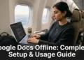 Person typing on laptop using Google Docs offline mode while traveling without internet